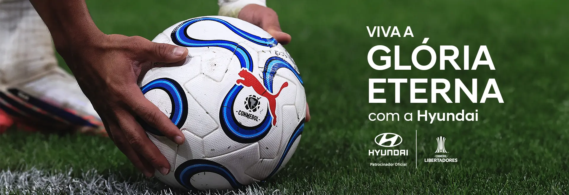 Jogador segurando a bola da CONMEBOL Libertadores™ para cobrar um escanteio. O texto diz: Viva a Glória Eterna com a Hyundai. 